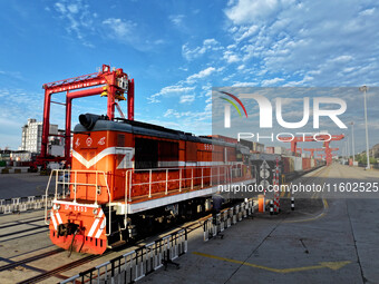 A China-Europe freight train is loaded with containers as it prepares to depart at the China-Kazakhstan (Lianyungang) Logistics Cooperation...