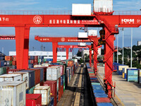 Large machinery loads containers onto a China-Europe freight train at the China-Kazakhstan (Lianyungang) logistics cooperation base in Liany...