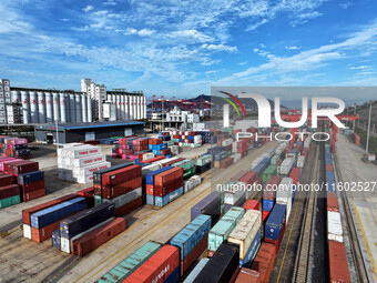 Large machinery loads containers onto a China-Europe freight train at the China-Kazakhstan (Lianyungang) logistics cooperation base in Liany...