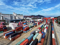 Large machinery loads containers onto a China-Europe freight train at the China-Kazakhstan (Lianyungang) logistics cooperation base in Liany...