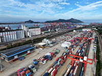 Large machinery loads containers onto a China-Europe freight train at the China-Kazakhstan (Lianyungang) logistics cooperation base in Liany...