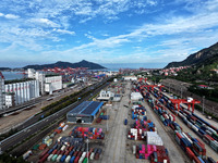 Large machinery loads containers onto a China-Europe freight train at the China-Kazakhstan (Lianyungang) logistics cooperation base in Liany...