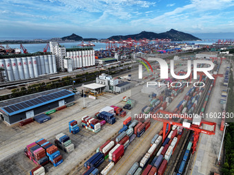 Large machinery loads containers onto a China-Europe freight train at the China-Kazakhstan (Lianyungang) logistics cooperation base in Liany...