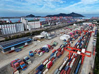 Large machinery loads containers onto a China-Europe freight train at the China-Kazakhstan (Lianyungang) logistics cooperation base in Liany...