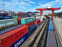 Large machinery loads containers onto a China-Europe freight train at the China-Kazakhstan (Lianyungang) logistics cooperation base in Liany...