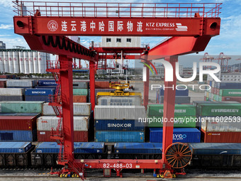 Large machinery loads containers onto a China-Europe freight train at the China-Kazakhstan (Lianyungang) logistics cooperation base in Liany...