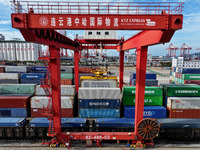 Large machinery loads containers onto a China-Europe freight train at the China-Kazakhstan (Lianyungang) logistics cooperation base in Liany...