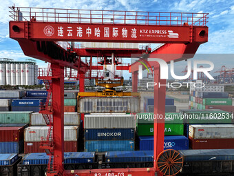 Large machinery loads containers onto a China-Europe freight train at the China-Kazakhstan (Lianyungang) logistics cooperation base in Liany...