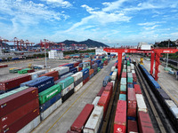 Large machinery loads containers onto a China-Europe freight train at the China-Kazakhstan (Lianyungang) logistics cooperation base in Liany...