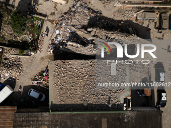 People dig through the rubble of a building that collapses in Saviano, near Naples, on Sunday morning. According to initial reconstructions,...