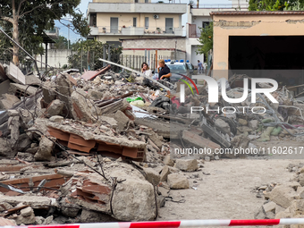 People dig through the rubble of a building that collapses in Saviano, near Naples, on Sunday morning. According to initial reconstructions,...