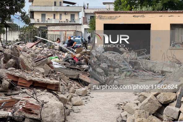 People dig through the rubble of a building that collapses in Saviano, near Naples, on Sunday morning. According to initial reconstructions,...