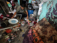 A Palestinian man inspects the damage in a room of a school sheltering displaced people after it is hit by an Israeli airstrike in the Nusei...