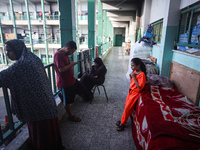 Palestinians stand at a school sheltering displaced people after an Israeli air strike hits the site in Nuseirat, Gaza Strip, on September 2...