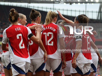 Players gather to celebrate Arsenal's opening goal during the Barclays FA Women's Super League match between Arsenal and Manchester City at...