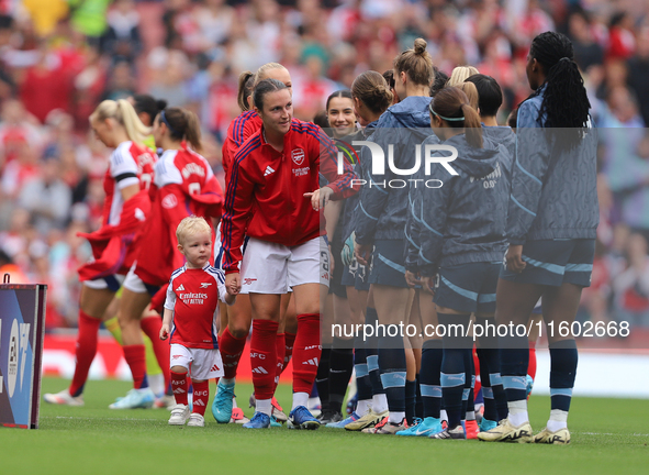 Lotte Wobben Moy stands with a mascot before the Barclays FA Women's Super League match between Arsenal and Manchester City at the Emirates...