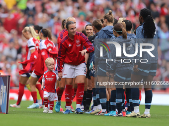 Lotte Wobben Moy stands with a mascot before the Barclays FA Women's Super League match between Arsenal and Manchester City at the Emirates...