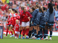 Lotte Wobben Moy stands with a mascot before the Barclays FA Women's Super League match between Arsenal and Manchester City at the Emirates...