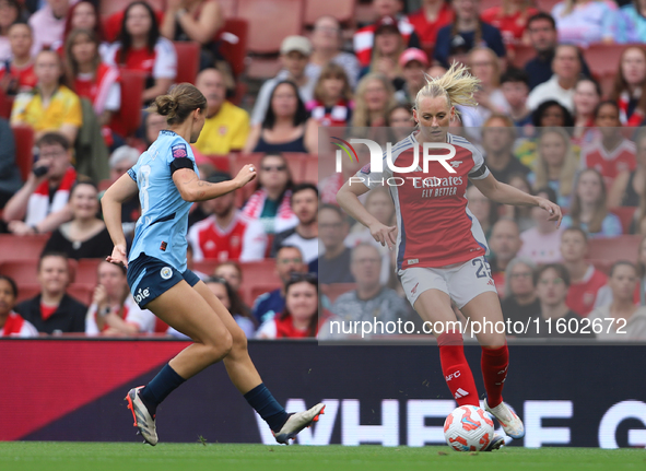 Kerstin Casparij challenges Stina Blackstenius during the Barclays FA Women's Super League match between Arsenal and Manchester City at the...