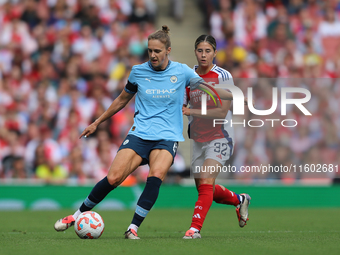 Krya Cooney Cross challenges Vivianne Miedema during the Barclays FA Women's Super League match between Arsenal and Manchester City at the E...