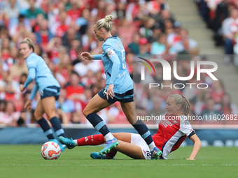 Frida Maanum gets the ball off Alex Greenwood during the Barclays FA Women's Super League match between Arsenal and Manchester City at the E...