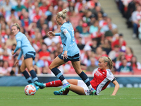 Frida Maanum gets the ball off Alex Greenwood during the Barclays FA Women's Super League match between Arsenal and Manchester City at the E...