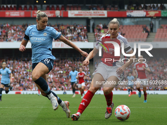 Alanna Kennedy challenges Arsenal's Alessia Russo during the Barclays FA Women's Super League match between Arsenal and Manchester City at t...