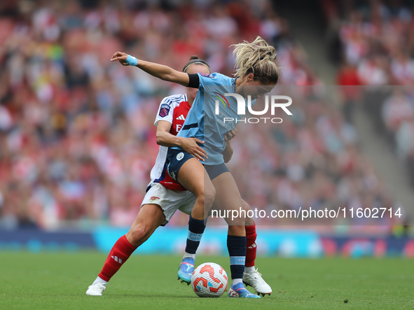 A player tangles during the Barclays FA Women's Super League match between Arsenal and Manchester City at the Emirates Stadium in London, En...