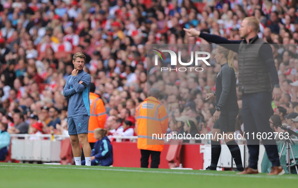 The manager and coaching staff stand on the sidelines during the Barclays FA Women's Super League match between Arsenal and Manchester City...