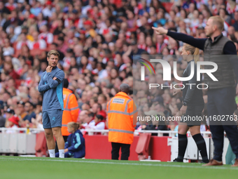 The manager and coaching staff stand on the sidelines during the Barclays FA Women's Super League match between Arsenal and Manchester City...