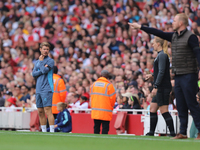 The manager and coaching staff stand on the sidelines during the Barclays FA Women's Super League match between Arsenal and Manchester City...