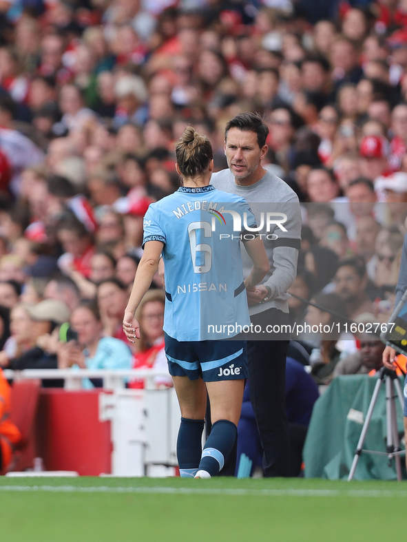 Vivianne Miedema embraces the manager Gareth Taylor during the Barclays FA Women's Super League match between Arsenal and Manchester City at...