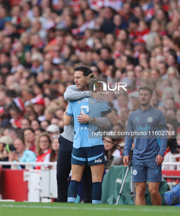 Vivianne Miedema embraces the manager Gareth Taylor during the Barclays FA Women's Super League match between Arsenal and Manchester City at...