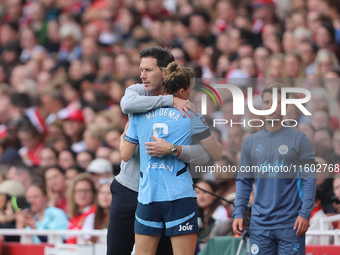 Vivianne Miedema embraces the manager Gareth Taylor during the Barclays FA Women's Super League match between Arsenal and Manchester City at...