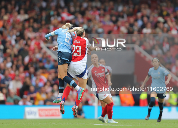 Alex Greenwood and Alessia Russo jump for the ball during the Barclays FA Women's Super League match between Arsenal and Manchester City at...