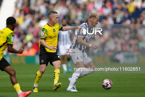 Uros Racic of West Bromwich Albion in action with Adam Forshaw of Plymouth Argyle during the Sky Bet Championship match between West Bromwic...