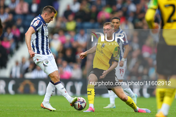 Jed Wallace of West Bromwich (L) in action with Kornel Szucs of Plymouth Argyle during the Sky Bet Championship match between West Bromwich...