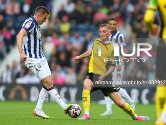 Jed Wallace of West Bromwich (L) in action with Kornel Szucs of Plymouth Argyle during the Sky Bet Championship match between West Bromwich...