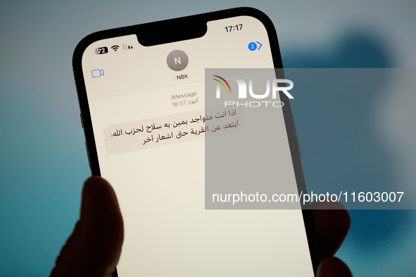 A text message in Arabic calling on people to leave areas risking strikes by the Israel Defence Forces (IDF) is seen on a phone in this illu...