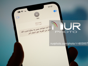 A text message in Arabic calling on people to leave areas risking strikes by the Israel Defence Forces (IDF) is seen on a phone in this illu...