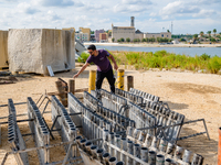 A technician inserts the bombs into the mortar for the preparation of the fireworks display at the New Port under construction in Molfetta,...