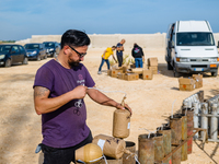 A technician inserts the bombs into the mortar for the preparation of the fireworks display at the New Port under construction in Molfetta,...