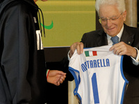 Sergio Mattarella receives a volleyball shirt dedicated to him from Anna Danesi during the return ceremony of the Flag of the Italian athlet...