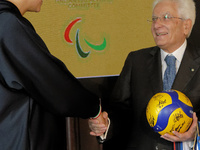 Sergio Mattarella receives a volleyball shirt dedicated to him from Anna Danesi during the return ceremony of the Flag of the Italian athlet...