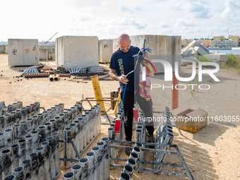 A technician inserts the bombs into the mortar for the preparation of the fireworks display at the New Port under construction in Molfetta,...