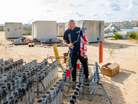 A technician inserts the bombs into the mortar for the preparation of the fireworks display at the New Port under construction in Molfetta,...