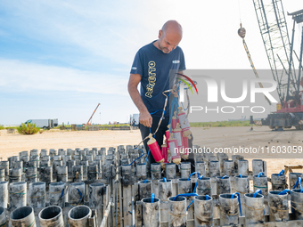 A technician inserts the bombs into the mortar for the preparation of the fireworks display at the New Port under construction in Molfetta,...