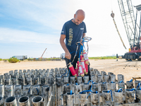 A technician inserts the bombs into the mortar for the preparation of the fireworks display at the New Port under construction in Molfetta,...