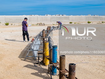 Technicians prepare the fireworks display at the New Port under construction in Molfetta, Italy, on September 22, 2024. On the final day of...