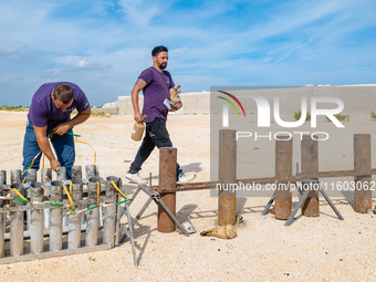 Technicians prepare the fireworks display at the New Port under construction in Molfetta, Italy, on September 22, 2024. On the final day of...